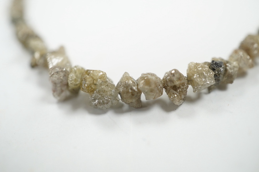 A single strand rough cut diamond necklace, with 750 yellow metal clasp, 40cm. Condition - fair